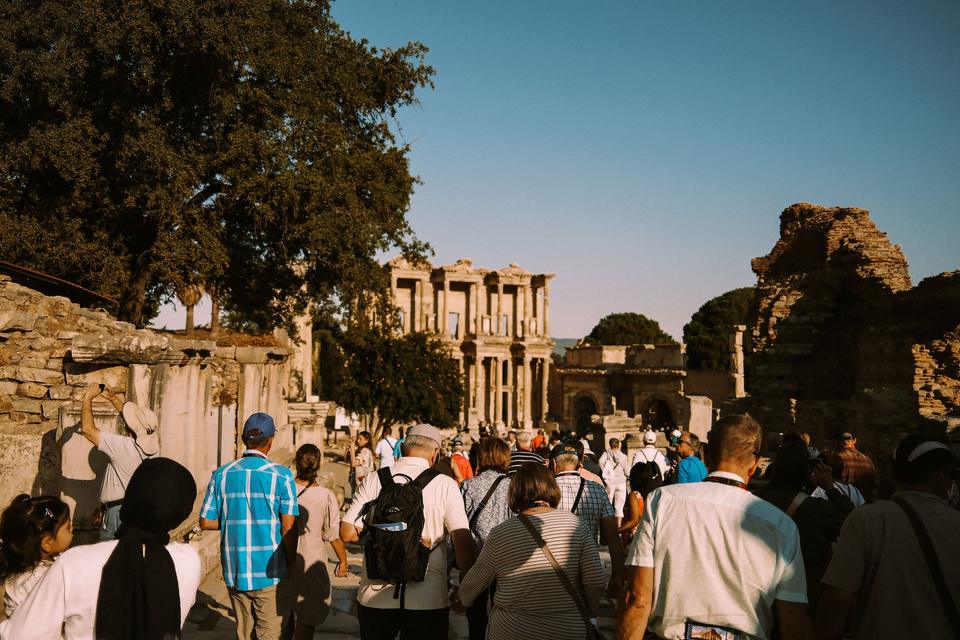 Visitors walking down marble Curetes Street toward the Library of Celsus
