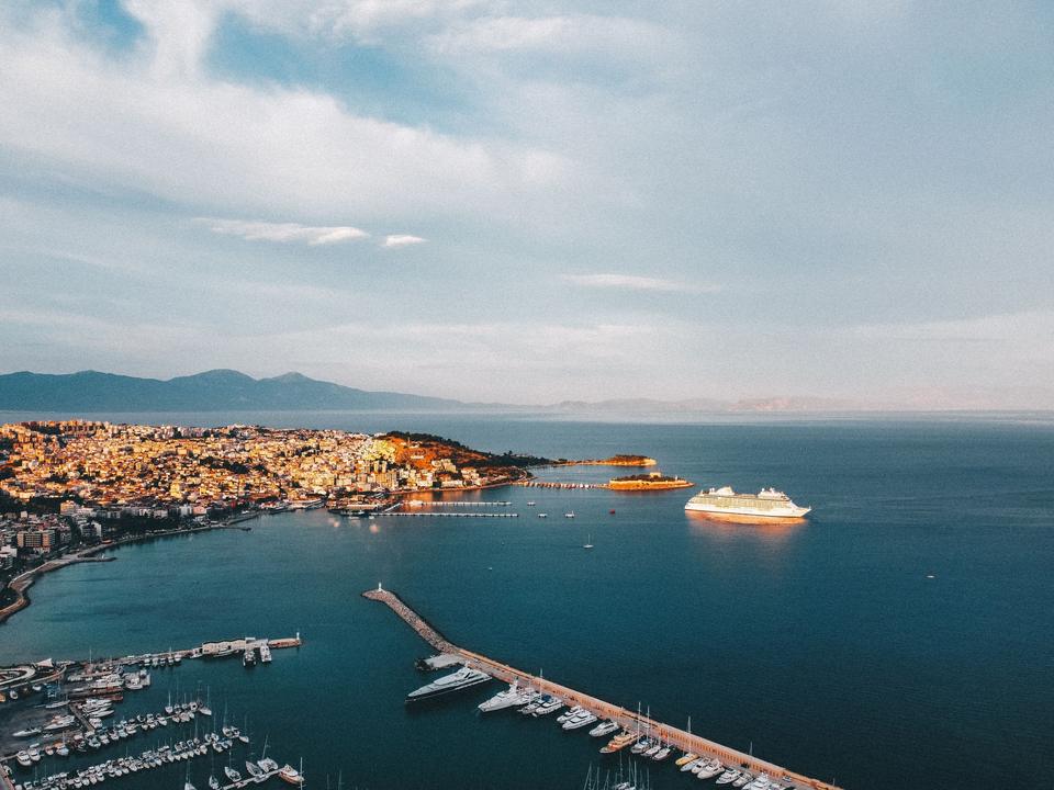 Cruise ship at Kusadasi port with Pigeon Island lit in golden hour light