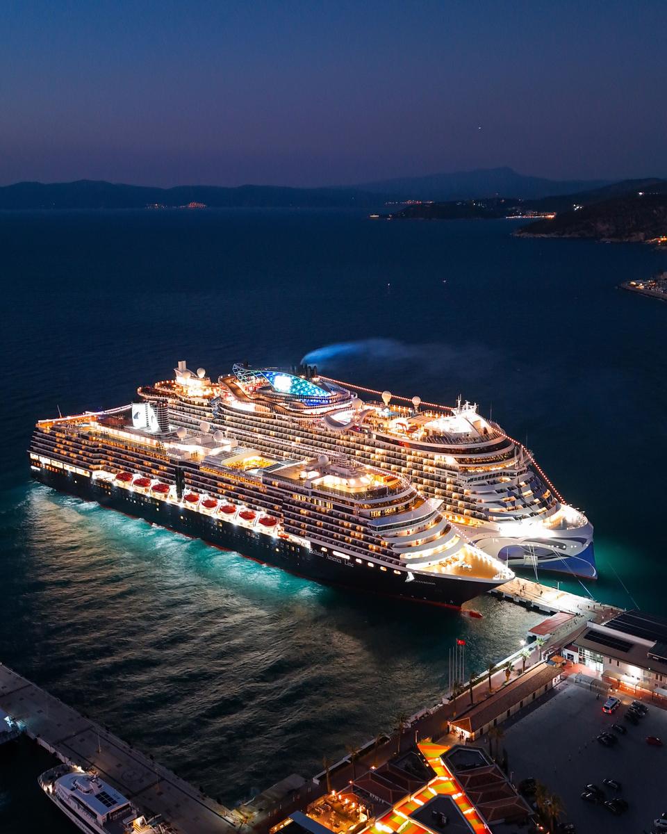 Cruise ships lit up at Kusadasi port at night, seen from above