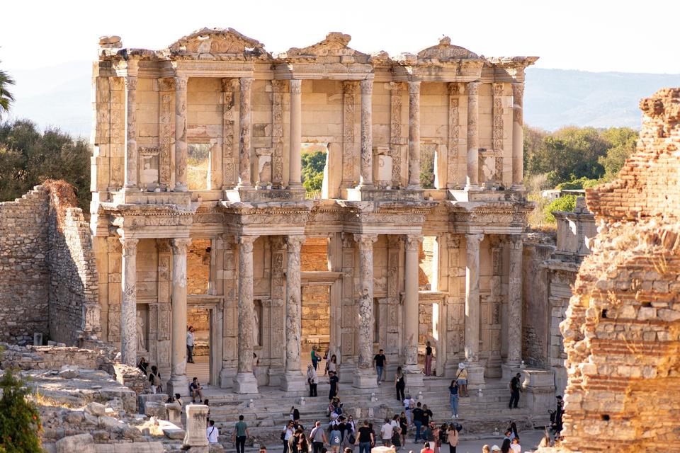 Crowd of visitors gathered on the steps of the Library of Celsus