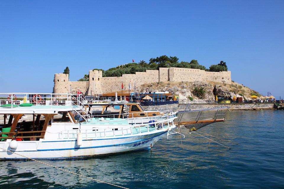 Tour boats docked below the fortress walls on Kusadasi's Pigeon Island